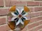Stained glass suncatcher in front of brick wall