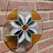 Stained glass suncatcher in front of brick wall